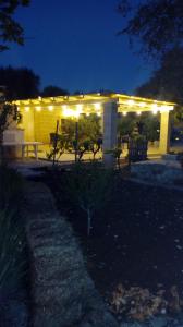 a lit up pergola with lights on it at night at Agriturismo Grotta Di Figazzano in Cisternino