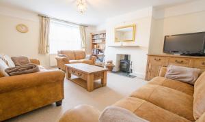 a living room with two couches and a tv at Cloudbreak Braunton, Sleeps 8 - Hot Tub hire - Dog Friendly in Braunton