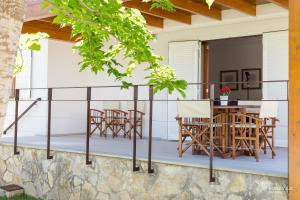 a deck with chairs and tables on a house at Berganti in Port d'Alcudia