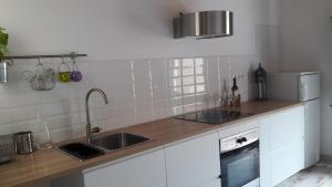 a kitchen with a sink and a refrigerator at BlauMasnou One step to the beach! in El Masnou
