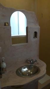 a bathroom with a stone sink and a mirror at BlauMasnou One step to the beach! in El Masnou