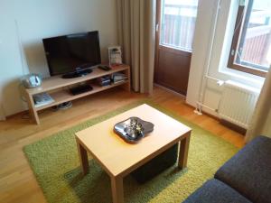 a living room with a coffee table and a television at Apartment Ylläs Ski Chalets 7202, Incl 2 lift tickets in winter season in Ylläsjärvi