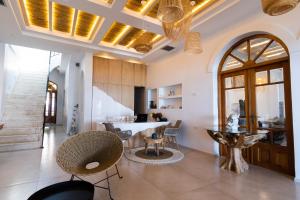 a large living room with a table and chairs at Aktaion Beach Boutique Hotel & Spa in Skala