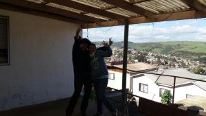 two people are standing on top of a roof at Hostal Panorámico in San Antonio