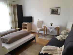 a living room with a couch and a table at Ferien- und Winzerhof Ute Braun in Nordheim