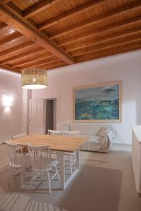 a dining room with a wooden table and chairs at M Residence Little Venice in Mikonos