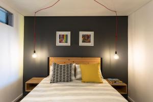a bedroom with a bed with a black accent wall at Brand new penthouse with waterfront views in Cape Town +34 photos