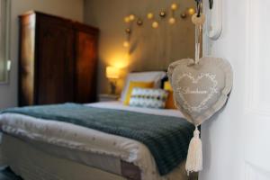 a bedroom with a bed with a heart on the wall at Le Val Daninière in Le Mesnil-Garnier