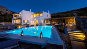 a villa with a swimming pool at night at Villa Gin & Tonic by Mykonos Mood in Agios Ioannis Mykonos