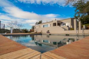 a house with a swimming pool in front of a house at Pestana Gramacho Residences in Ferragudo