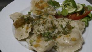 a white plate of food with dumplings and vegetables at Zajazd Zielona Gęś in Przytoczna 