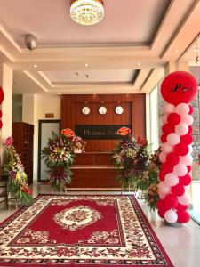 a lobby with a red carpet and red decorations at Pharma Hotel in Diện Biên Phủ