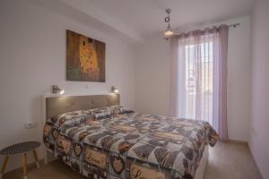 Postel nebo postele na pokoji v ubytování Apartman Madonnina