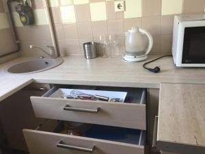 a kitchen counter with a drawer and a microwave at Lattino pietura in Rīga