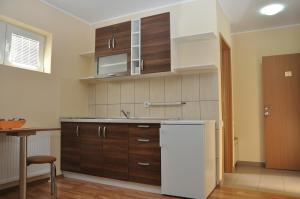 a kitchen with a white refrigerator and a table at Villa Dunja in Kragujevac