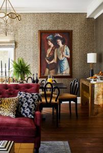 a living room with a painting of two women at The Cliffside Inn in Newport