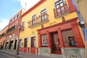 a row of colorful buildings on a street at Hotel Santa Regina in Guanajuato