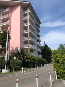 a building on the side of a road next to a street at Room 211 - Aparthotel Jadranka in Portorož