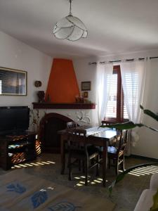 a living room with a table and a fireplace at Karmabnb in Cala Gonone