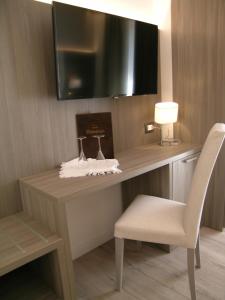 Uma TV ou centro de entretenimento em Hotel Belvedere