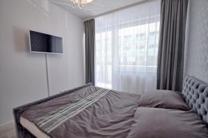 Posteľ alebo postele v izbe v ubytovaní AMD Apartamenty Bliżej Morza