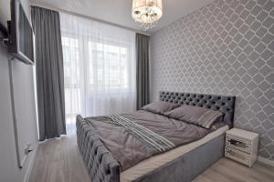 Posteľ alebo postele v izbe v ubytovaní AMD Apartamenty Bliżej Morza