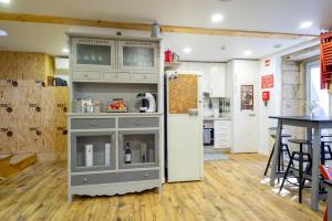 a kitchen with a cabinet and a refrigerator at Hostel Bulwark in Valença
