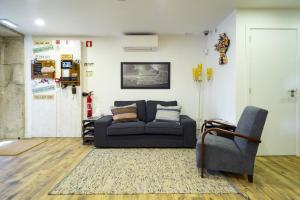 a living room with a couch and a chair at Hostel Bulwark in Valença