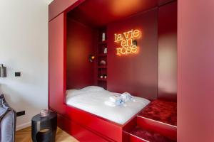 a red bed with two teddy bears in it at CMG Galeries Lafayette / Madeleine D in Paris