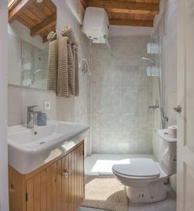 a bathroom with a sink and a toilet and a shower at attico vista oceano e città 3 camere 3 bagni WiFi AC in Morro del Jable +13 photos