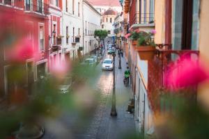 a view of a street with a car on the road at Hotel Santa Regina in Guanajuato