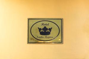 a sign on a wall with a crown on it at Hotel Santa Regina in Guanajuato