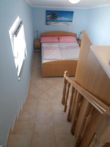 Postel nebo postele na pokoji v ubytování Apartmani Nina
