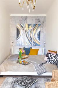 a bed in a room with paintings on the wall at Prague Castle Garden Apartment in Prague