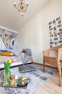 a living room with a bed and a tray of food at Prague Castle Garden Apartment in Prague