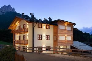 a house in the mountains at dusk at Casa Chris by AMA Val di Fassa in Pozza di Fassa