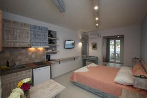 a bedroom with a bed and a kitchen with a sink at Bella Vista in Batsi