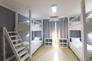 a room with three bunk beds and a staircase at Hostel Kyosheto in Kŭrdzhali