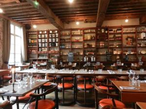 a restaurant with tables and chairs in a room at LA VILLA DES CHAMPS in Lille