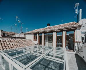 a glass roof on top of a house at 4U Hostel in Granada