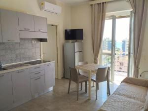 a kitchen with a table with chairs and a dining room at Via dei Mille 1, centrale e vista mare in Marina di Andora