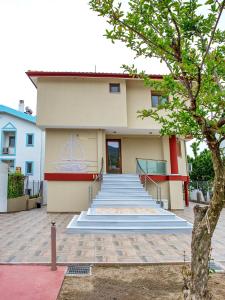 a building with blue stairs in front of it at Rent House Karavi in Iraklitsa