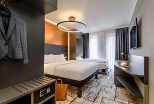 a hotel room with a bed and a desk at ibis Styles Bamberg in Bamberg +70 photos