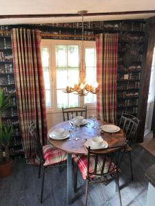 a dining room with a table and chairs and a window at The Stags Lodge in Newton on the Moor