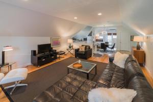 a living room with a leather couch and a living room at The Carriage House Loft in Kingston