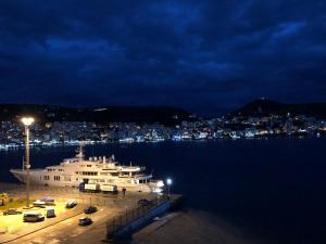 a large boat in the water at night at Port Side Sarande in Sarandë