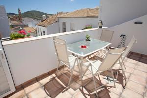 a small balcony with a table and chairs on it at EL PALOMAR in Algodonales