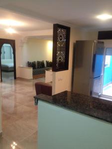 a kitchen with a counter top and a living room at Oued Laou - Ground Floor in Oued Laou