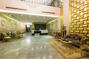 a lobby of a hotel with chairs and a table at LeChateau Boutique Hotel in Jeddah