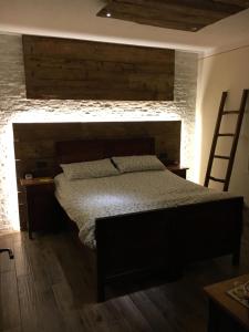 a bedroom with a bed and a brick wall at il Finferlo in Bellamonte